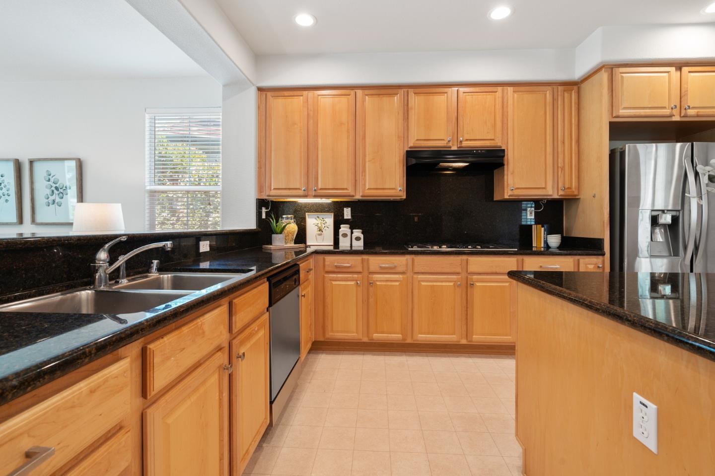 357 Pebble Beach Drive Brentwood, CA 94513 - Photo 21 of 56 a kitchen with granite countertop a sink a counter space appliances and cabinets