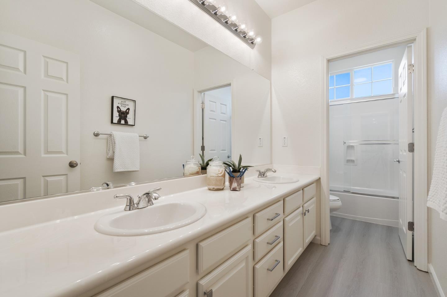 357 Pebble Beach Drive Brentwood, CA 94513 - Photo 46 of 56 a bathroom with double vanity sinks a toilet a mirror and vanity