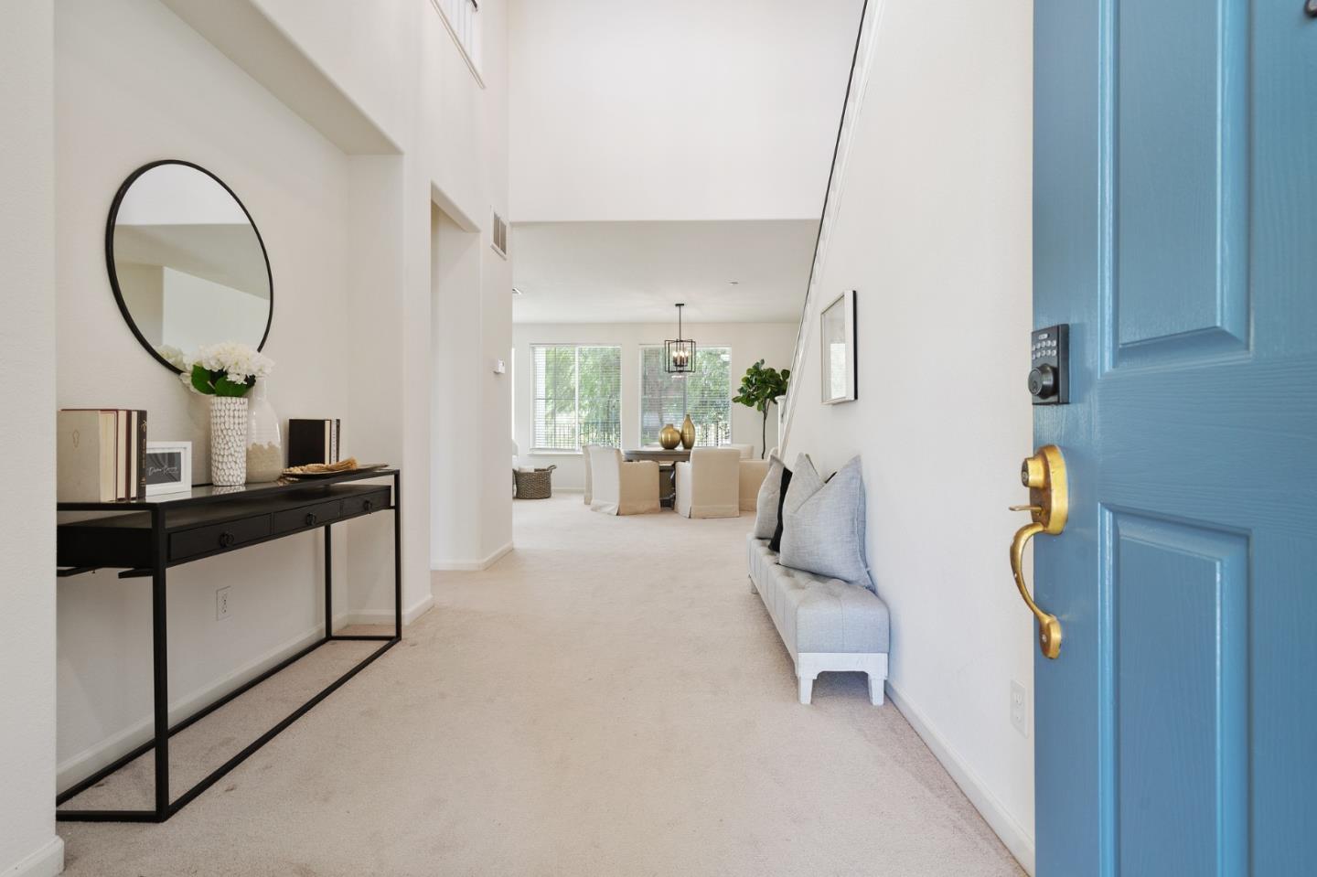 357 Pebble Beach Drive Brentwood, CA 94513 - Photo 5 of 56 a living room with furniture a mirror and a painting on the wall