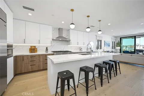 a kitchen with kitchen island a dining table and chairs