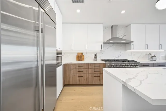 a kitchen with kitchen island a stove a table and chairs in it