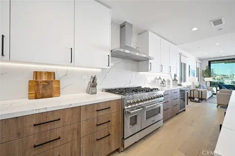 a dining room with furniture a chandelier and wooden floor