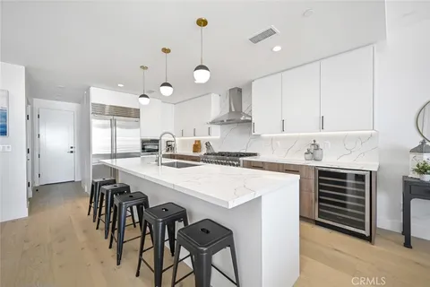 a kitchen with a refrigerator sink and couches