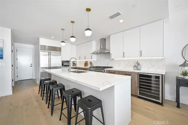 a kitchen with a refrigerator sink and couches