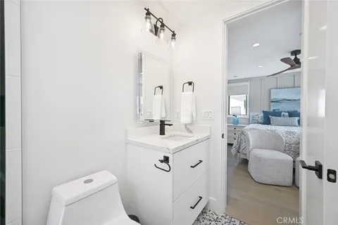 a bathroom with a sink toilet and mirror