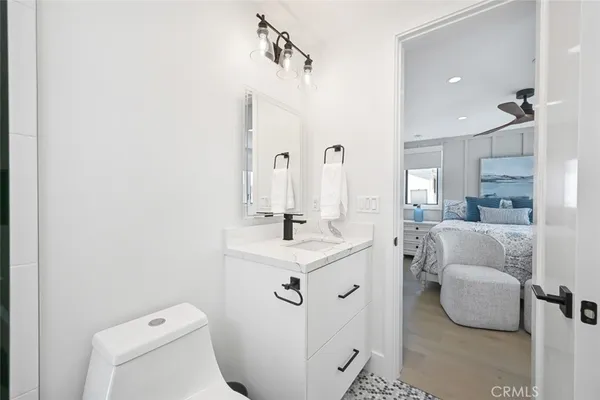 a bathroom with a sink toilet and mirror