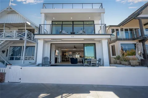 a view of a dining room with furniture and a chandelier