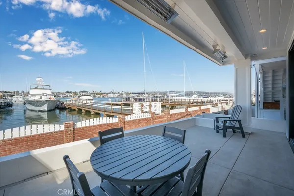 a living room with furniture kitchen view and a window
