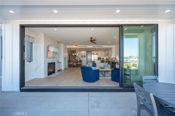 a living room with furniture and a view of kitchen