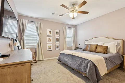 a bedroom with a bed dresser and a window