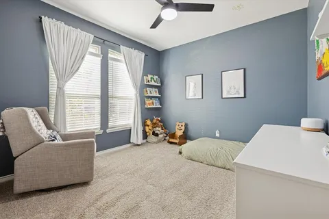 a bedroom with furniture and a large window