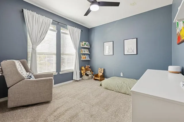 a bedroom with furniture and a large window