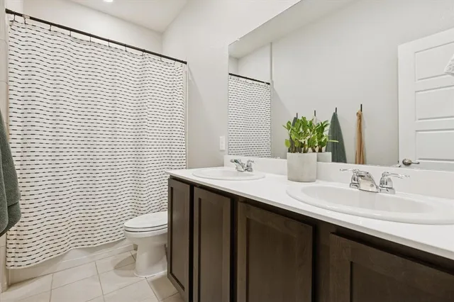 a bathroom with a sink toilet and mirror