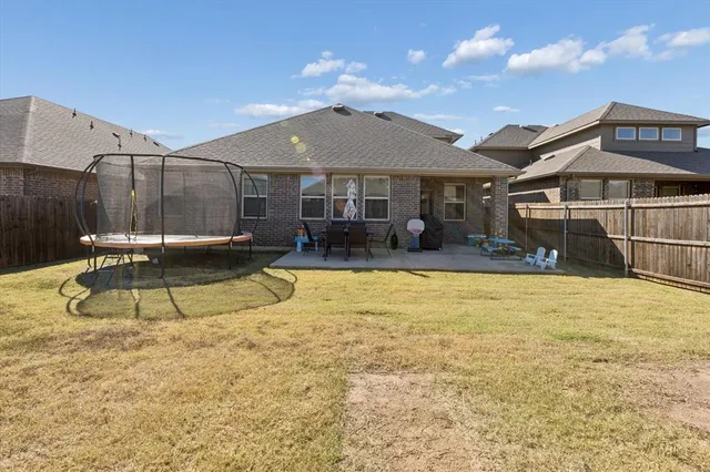 a view of a house with backyard and swimming pool