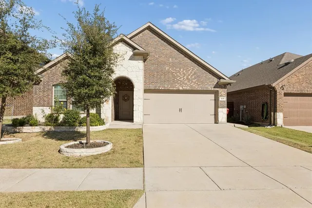 a view of a house with a yard and garage