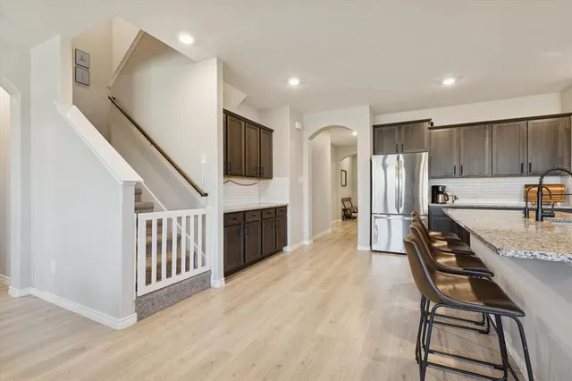 a kitchen with stainless steel appliances a refrigerator and a stove top oven