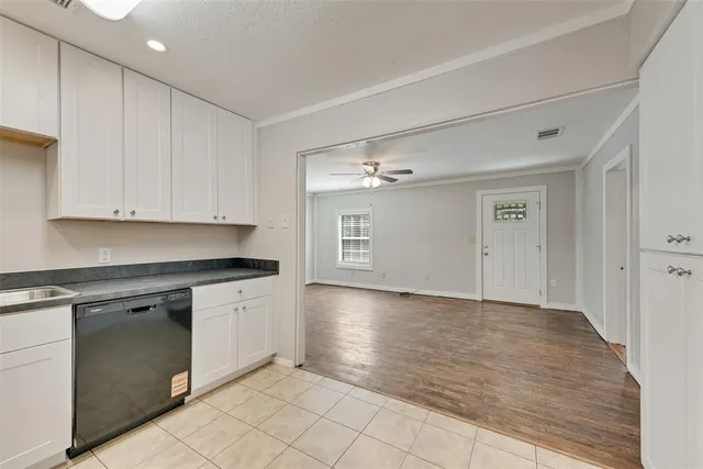 a kitchen with granite countertop a stove sink and refrigerator