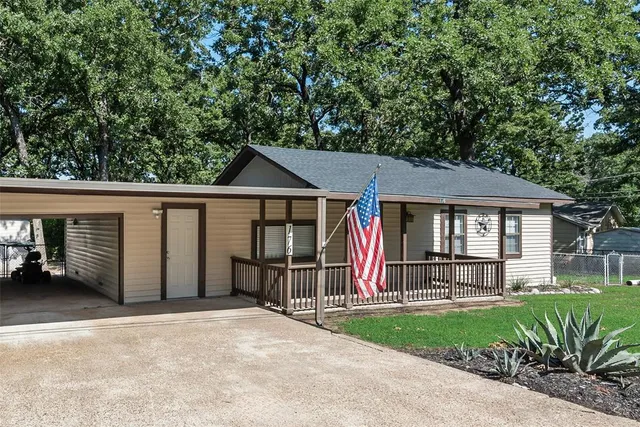 a front view of a house with a garden and plants