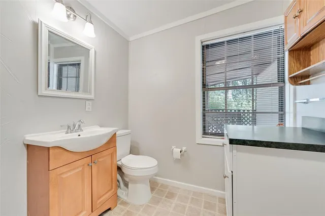 a bathroom with a sink a toilet and shower curtain
