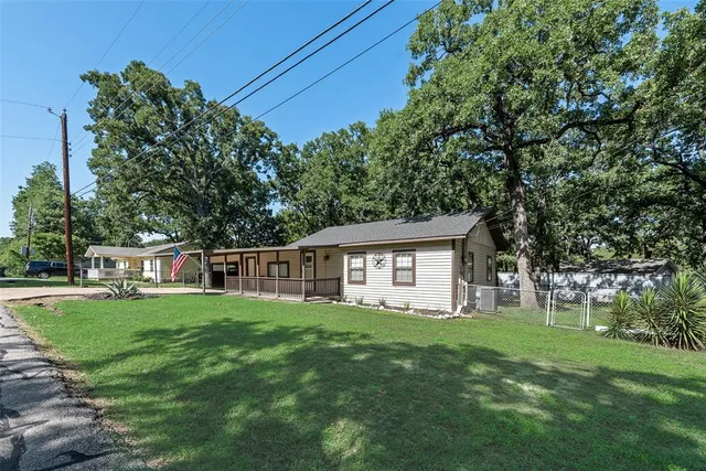 a house view with a sitting space and garden