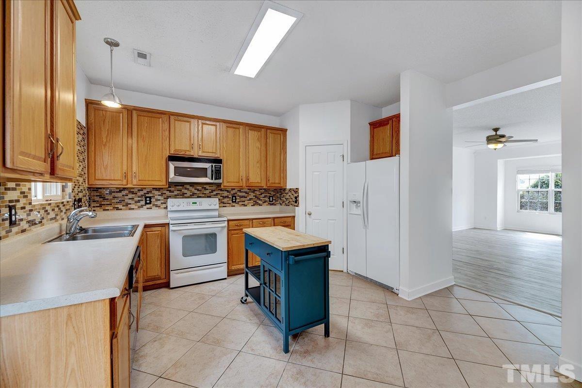 3367 Bridgeville Road Raleigh, NC 27610 - Photo 12 of 34 a kitchen with a sink appliances and cabinets