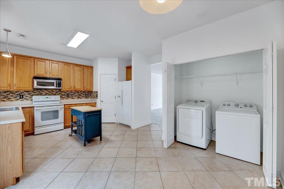 3367 Bridgeville Road Raleigh, NC 27610 - Photo 17 of 34 a kitchen with a stove a sink and a microwave