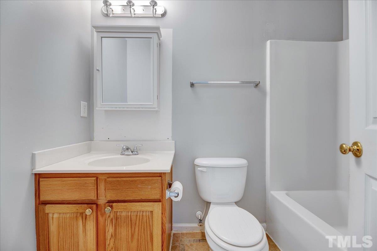 3367 Bridgeville Road Raleigh, NC 27610 - Photo 24 of 34 a bathroom with a sink a toilet and shower