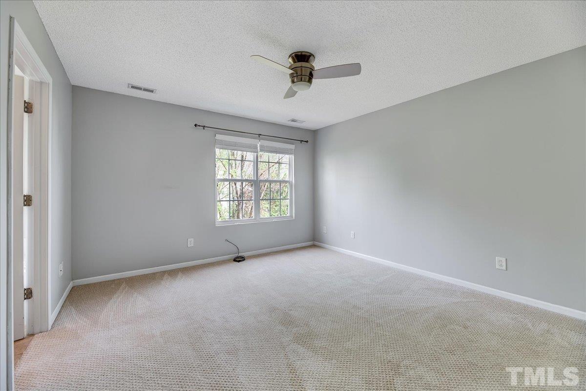3367 Bridgeville Road Raleigh, NC 27610 - Photo 25 of 34 an empty room with a window and a ceiling fan
