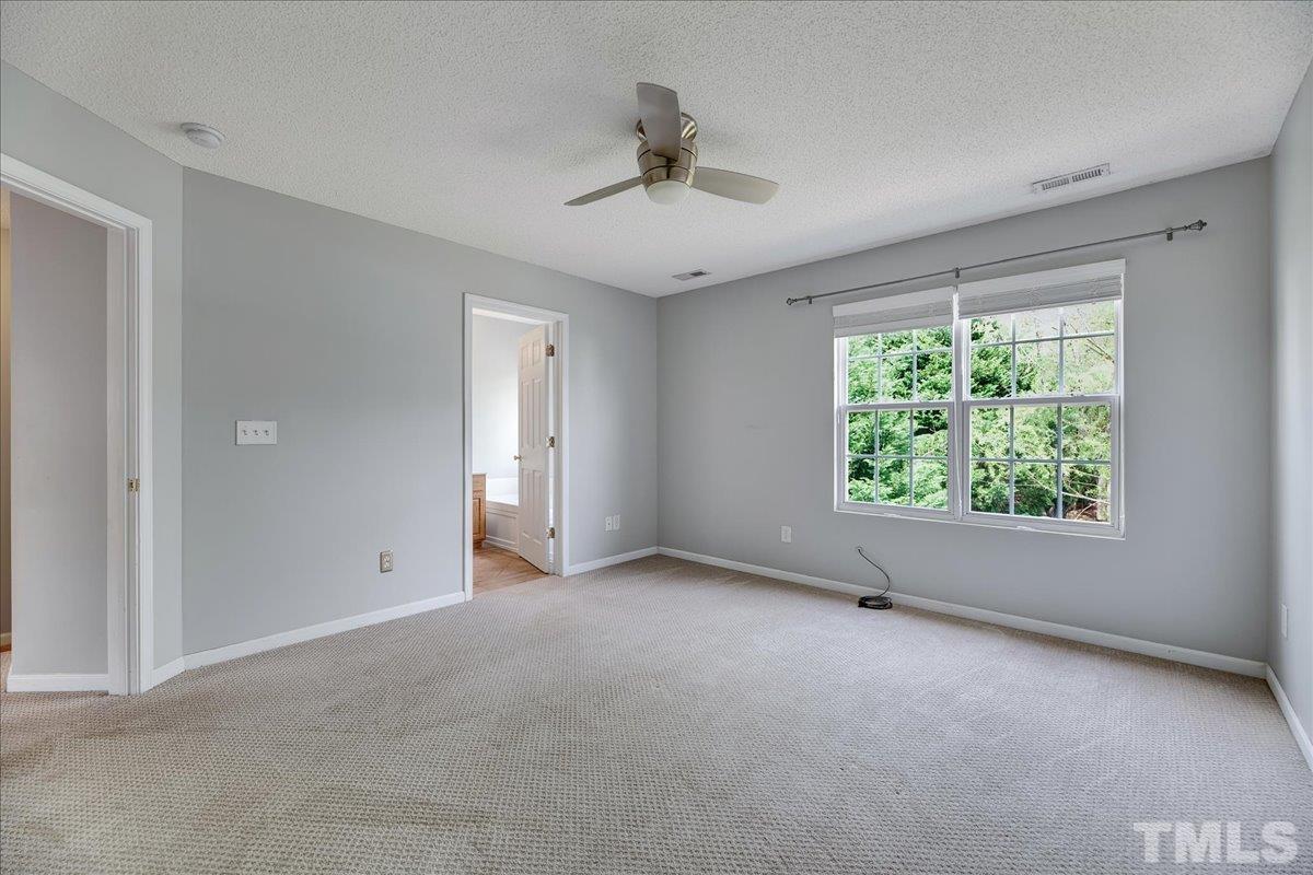 3367 Bridgeville Road Raleigh, NC 27610 - Photo 26 of 34 an empty room with a window and a ceiling fan