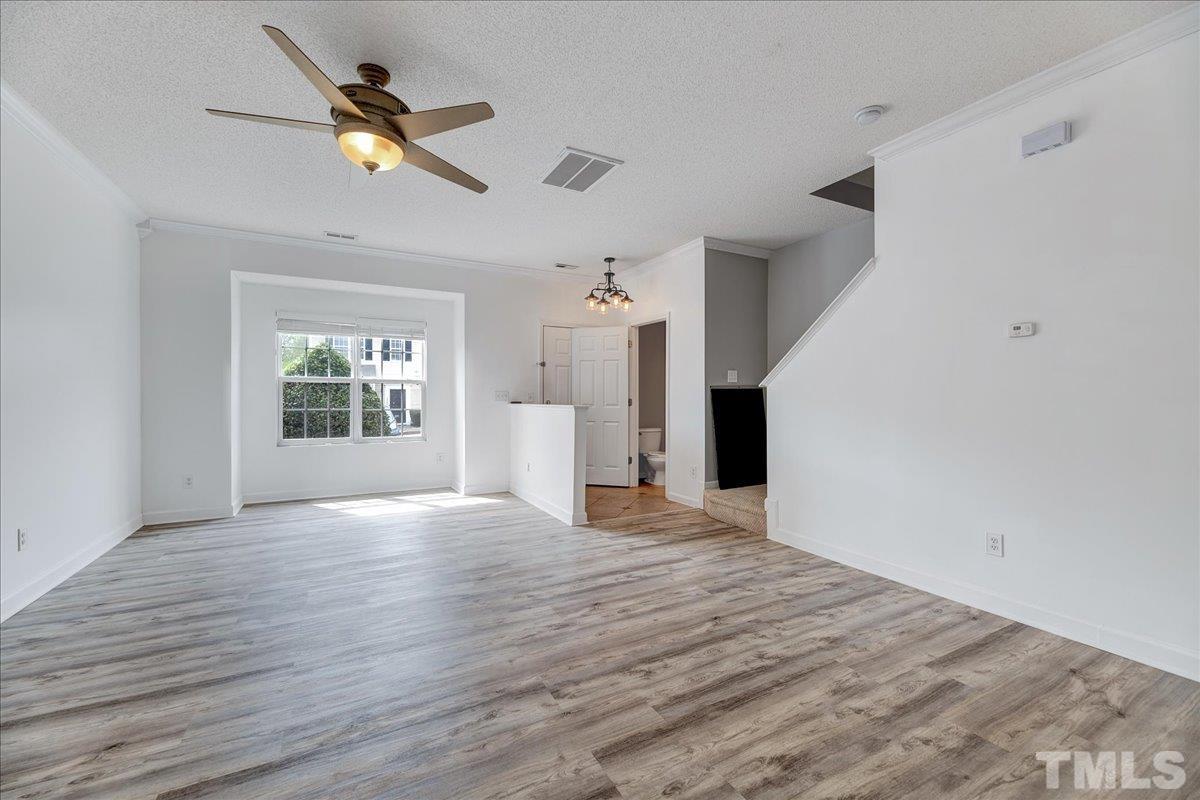 3367 Bridgeville Road Raleigh, NC 27610 - Photo 8 of 34 wooden floor in an empty room with a window