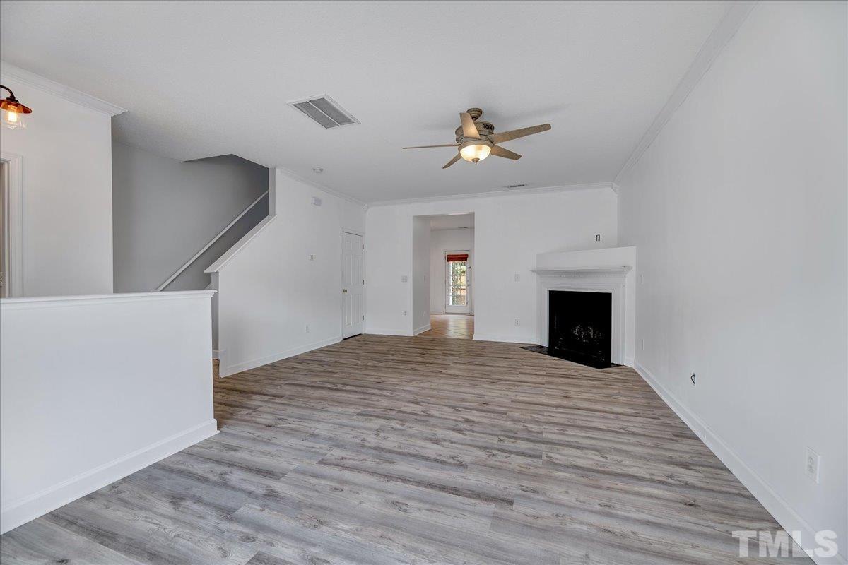 3367 Bridgeville Road Raleigh, NC 27610 - Photo 9 of 34 a view of empty room with a fireplace