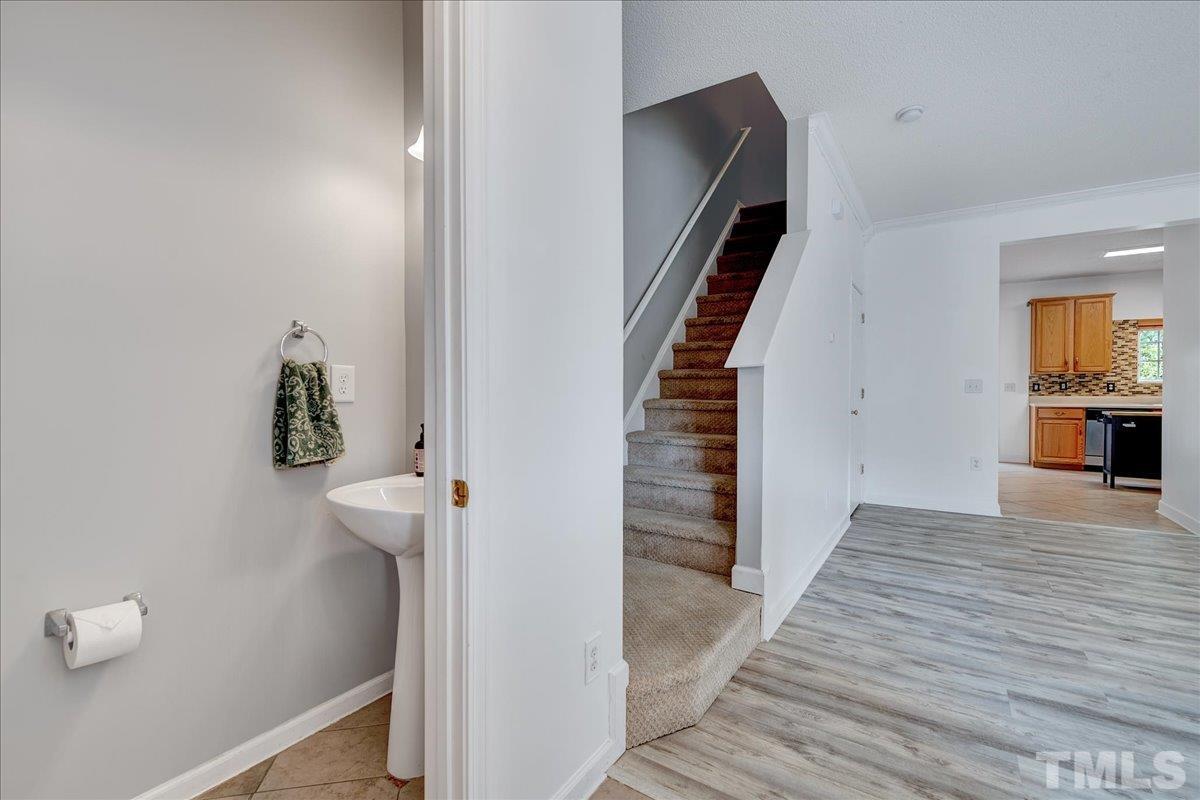 3367 Bridgeville Road Raleigh, NC 27610 - Photo 10 of 34 a view of a hallway with wooden floor and staircase