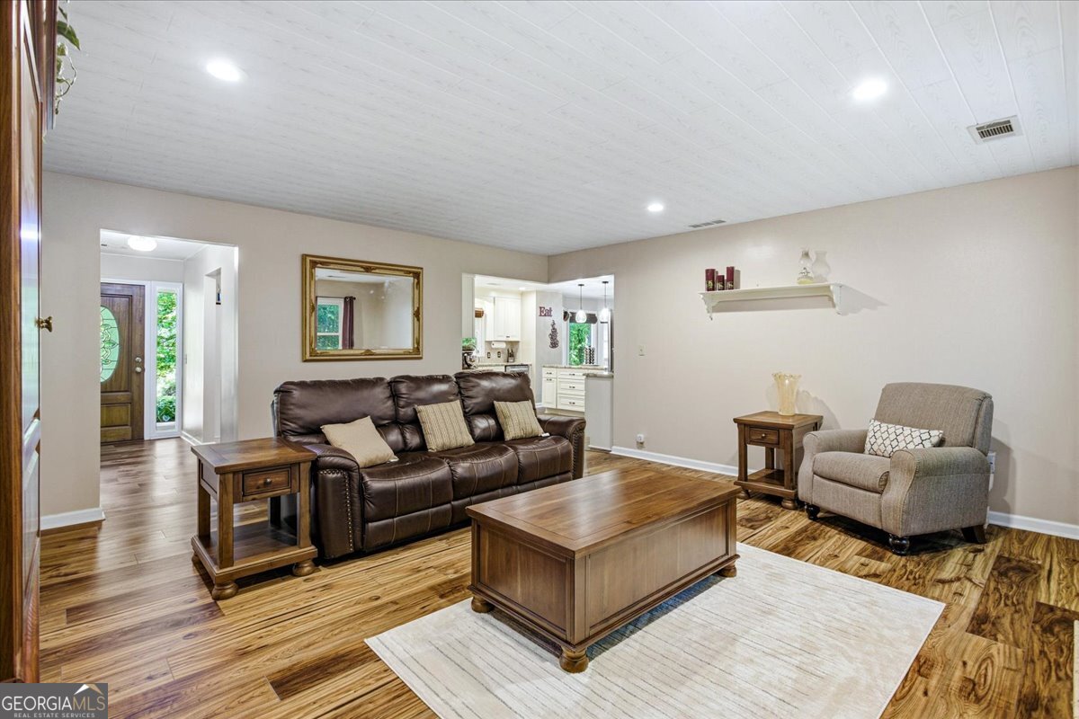 265 Floyd Road Hampton, GA 30228 - Photo 11 of 64 a living room with furniture and a wooden floor