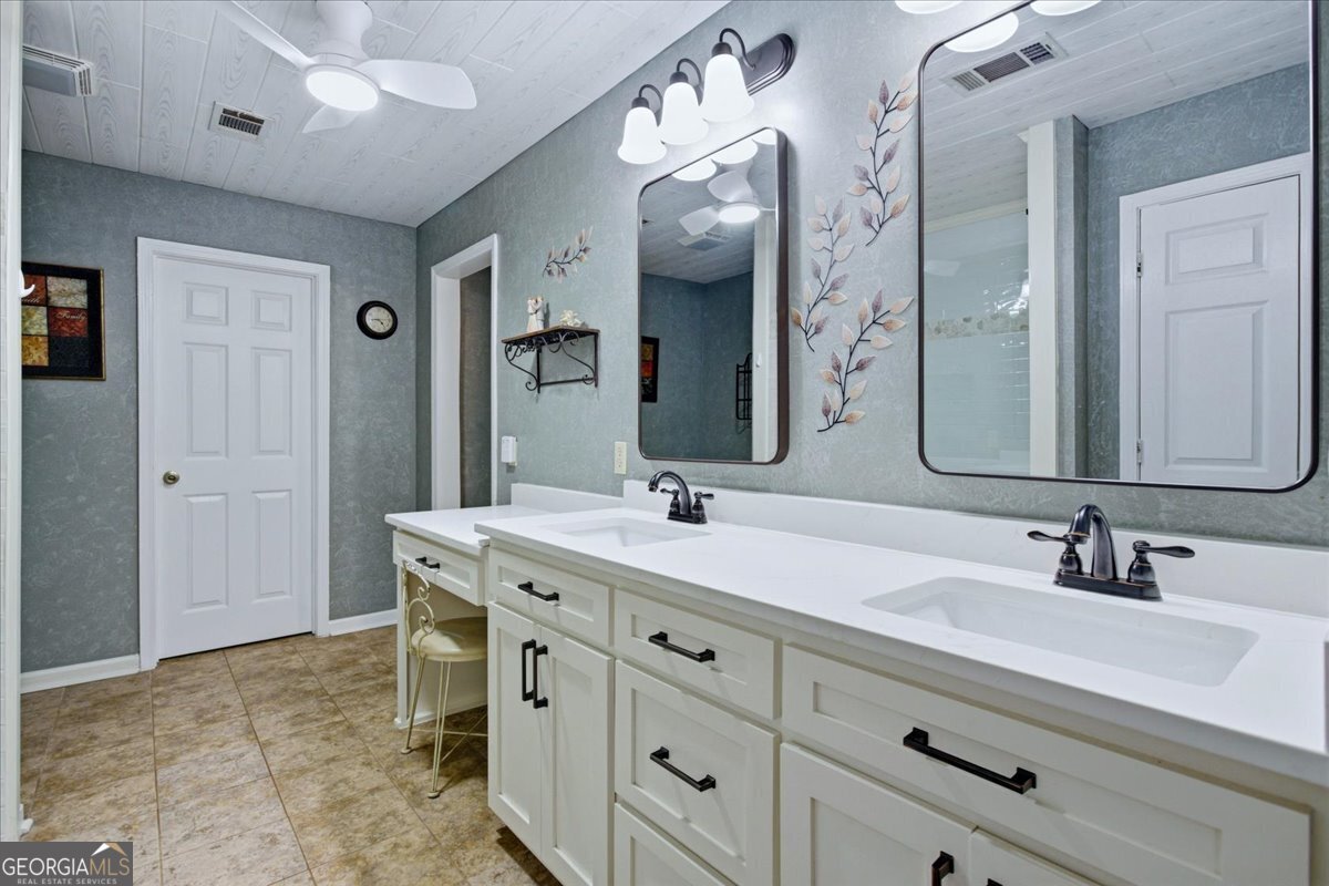 265 Floyd Road Hampton, GA 30228 - Photo 19 of 64 a bathroom with a double vanity sink mirror and