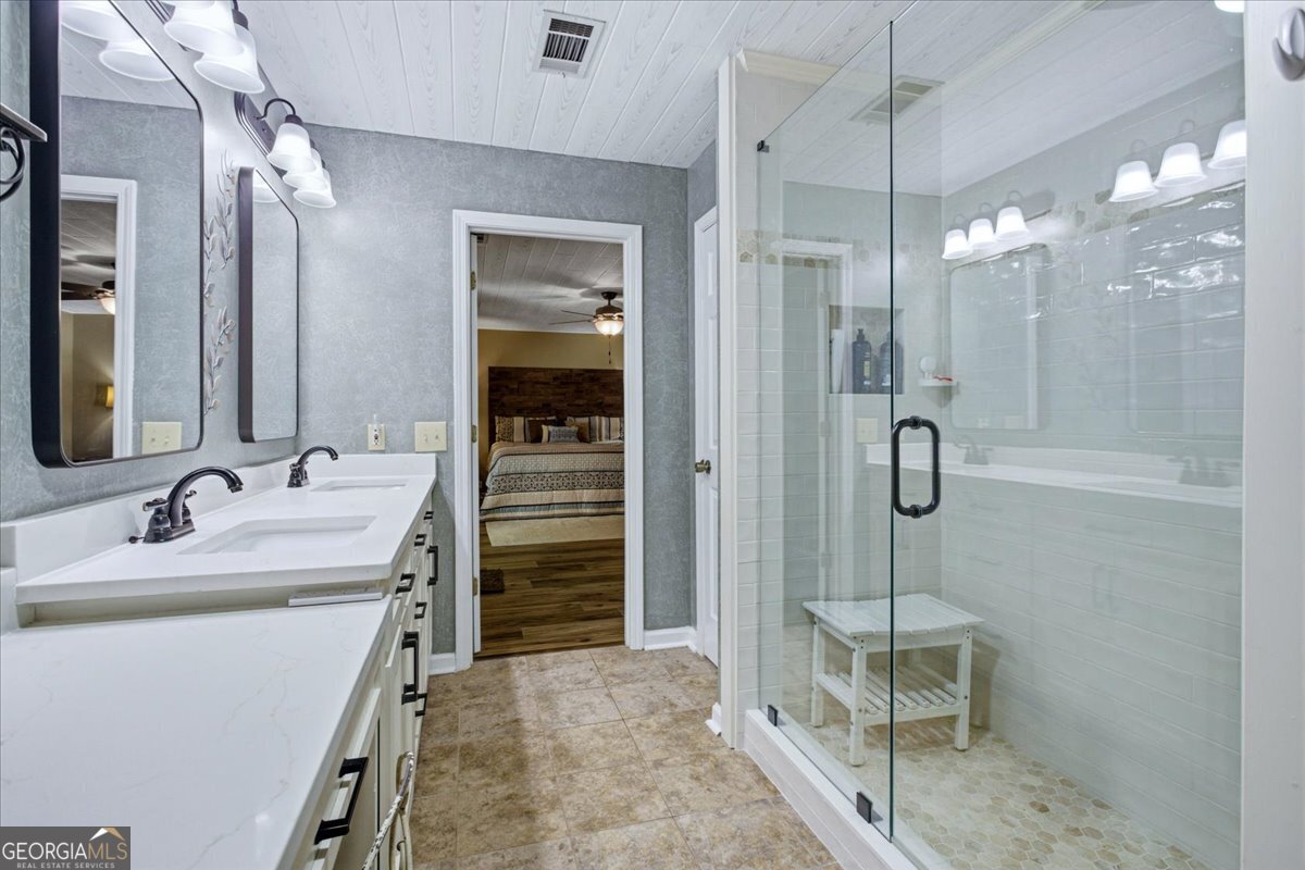 265 Floyd Road Hampton, GA 30228 - Photo 20 of 64 a bathroom with a sink a toilet a mirror and shower