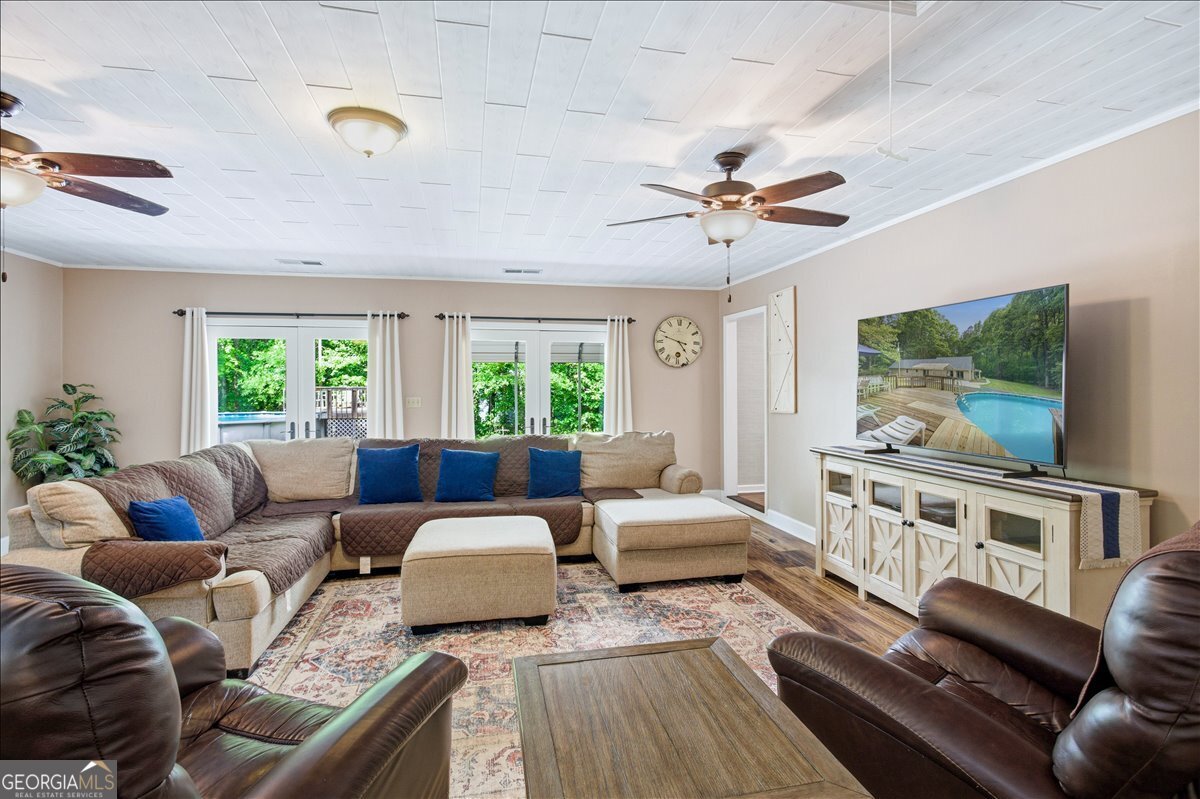 265 Floyd Road Hampton, GA 30228 - Photo 22 of 64 a living room with furniture and a flat screen tv