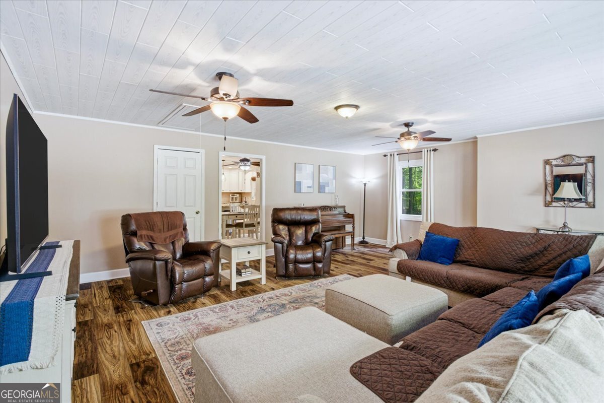 265 Floyd Road Hampton, GA 30228 - Photo 23 of 64 a living room with furniture ceiling fan and a rug