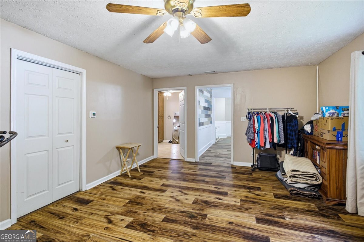 265 Floyd Road Hampton, GA 30228 - Photo 27 of 64 a bedroom with a bed and a chandelier