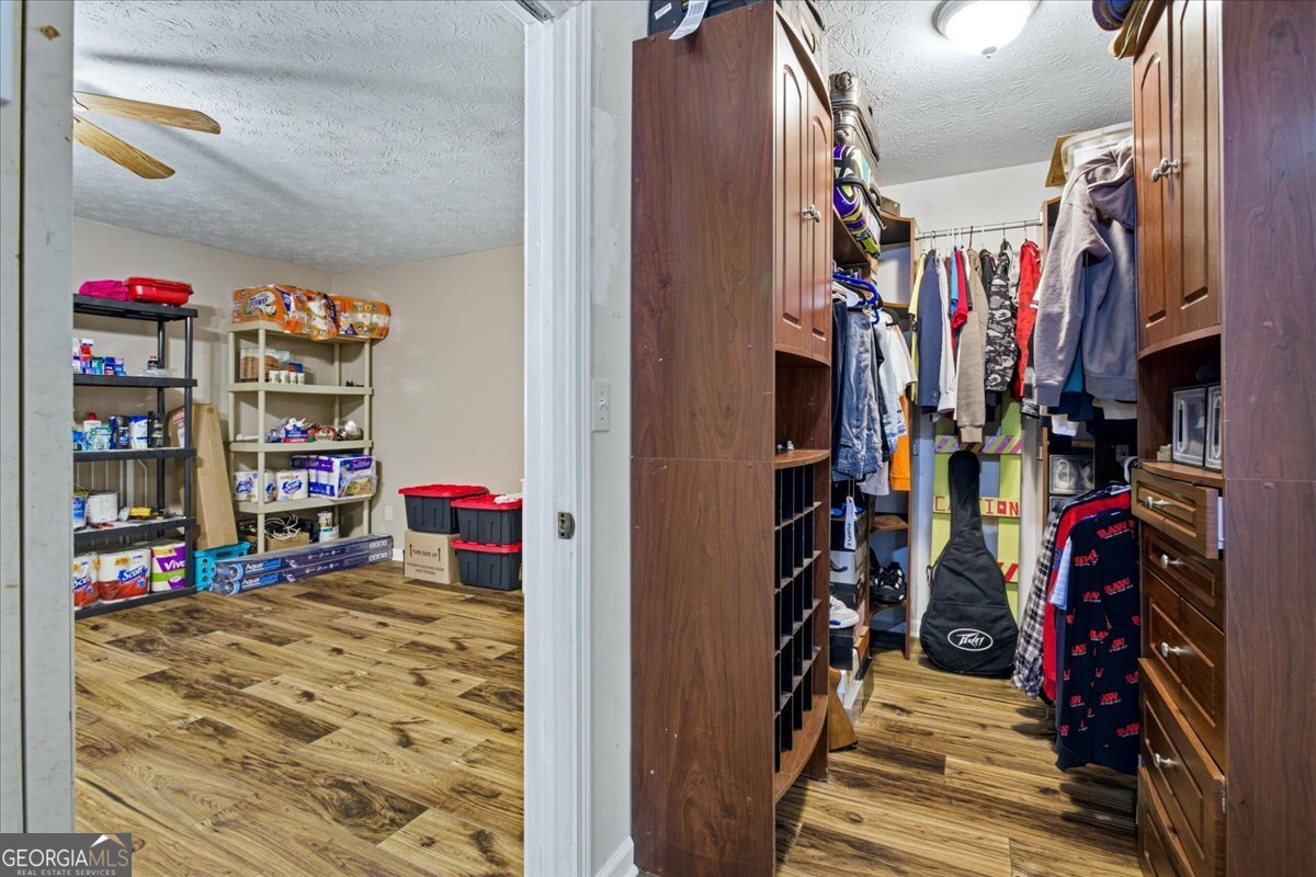 265 Floyd Road Hampton, GA 30228 - Photo 29 of 64 a view of walk in closet with clothes and shoes
