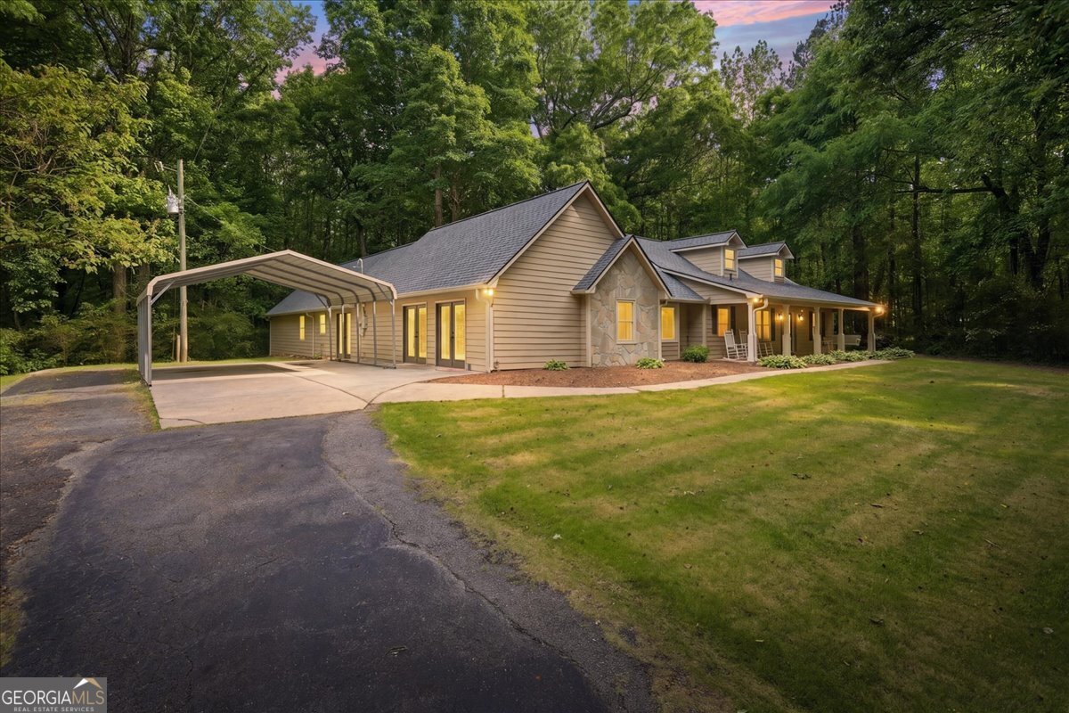 265 Floyd Road Hampton, GA 30228 - Photo 33 of 64 a front view of a house with a yard and trees