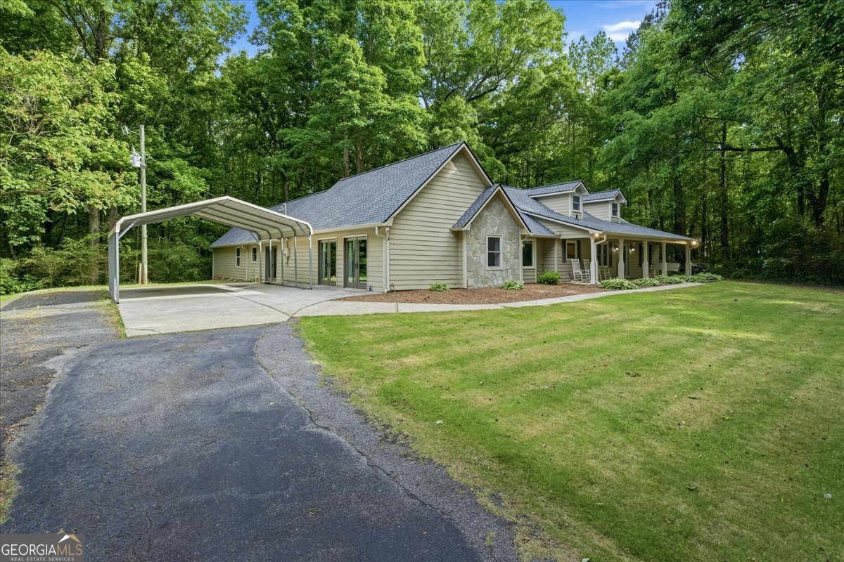 265 Floyd Road Hampton, GA 30228 - Photo 34 of 64 a front view of a house with a garden and trees