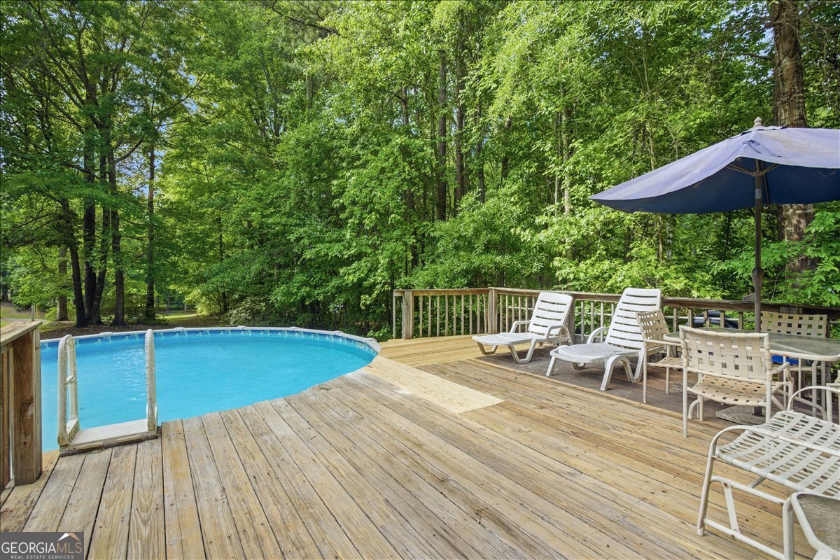 265 Floyd Road Hampton, GA 30228 - Photo 37 of 64 a view of a chairs and table on the wooden deck