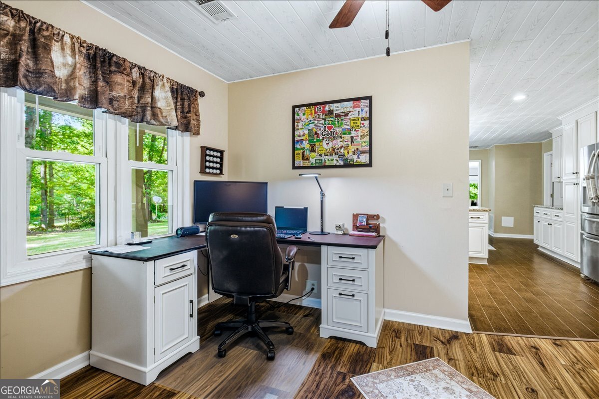 265 Floyd Road Hampton, GA 30228 - Photo 4 of 64 a view of a workspace with furniture and a window