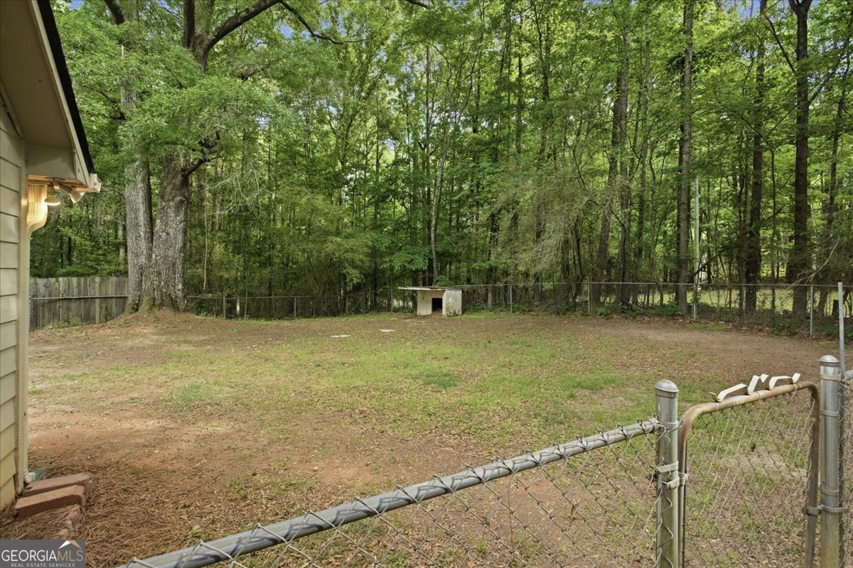265 Floyd Road Hampton, GA 30228 - Photo 43 of 64 a backyard of a house with lots of green space