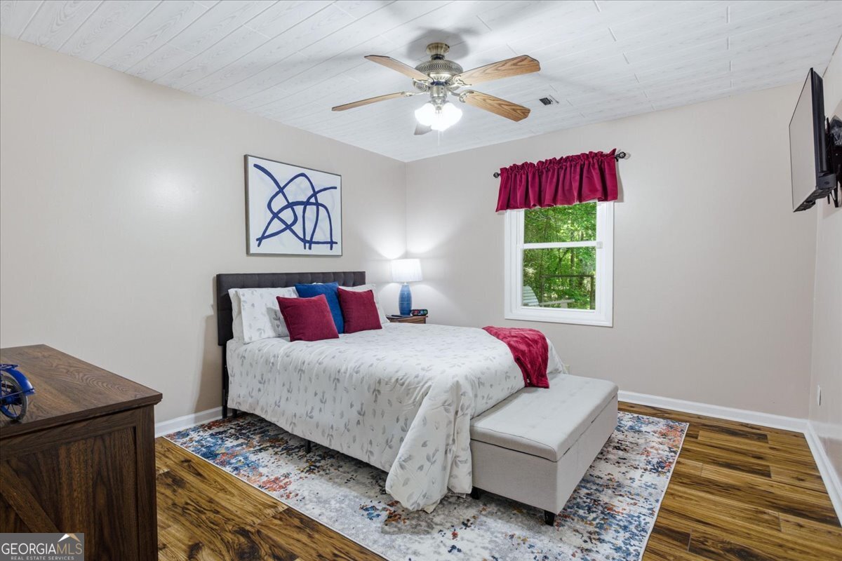 265 Floyd Road Hampton, GA 30228 - Photo 5 of 64 a bedroom with a bed and a window