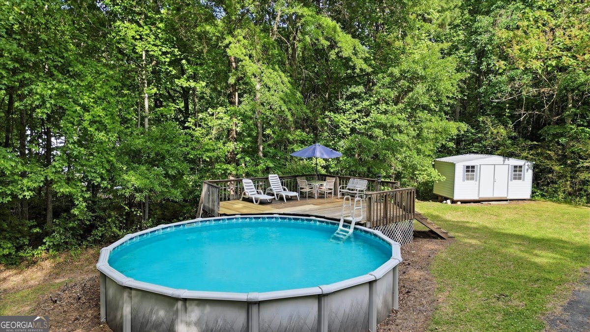 265 Floyd Road Hampton, GA 30228 - Photo 52 of 64 a view of a swimming pool with a yard and trees