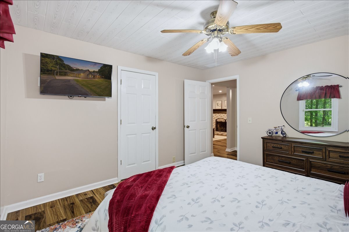 265 Floyd Road Hampton, GA 30228 - Photo 6 of 64 a bedroom with a bed and a chandelier