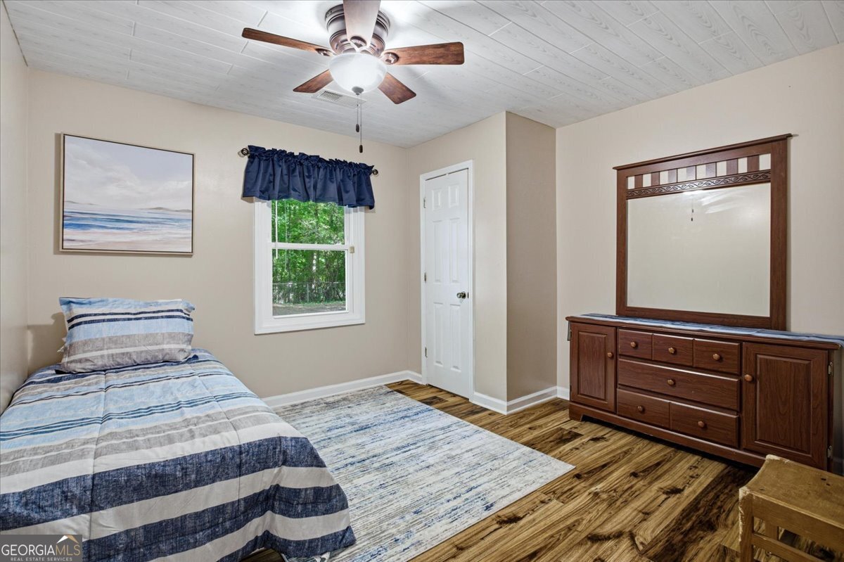 265 Floyd Road Hampton, GA 30228 - Photo 8 of 64 a bedroom with a bed and a window