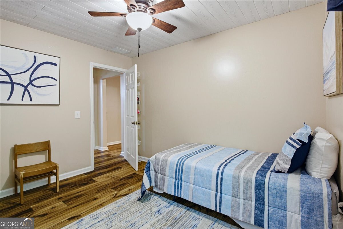 265 Floyd Road Hampton, GA 30228 - Photo 9 of 64 a bedroom with a bed and wooden floor