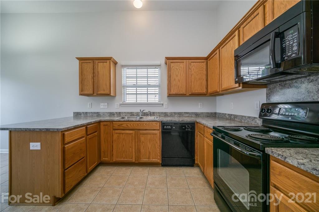 141 Rhyne Springs Road Mount Holly, NC 28120 - Photo 2 of 17 a kitchen with stainless steel appliances granite countertop a sink a stove a microwave and cabinets